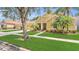 Lovely single-Gathering home featuring a well-manicured lawn, mature trees, and a spacious driveway at 14312 Paradise Tree Dr, Orlando, FL 32828