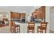 Spacious kitchen with wood cabinets, dark countertops, tile backsplash, stainless steel appliances, and breakfast bar seating at 14312 Paradise Tree Dr, Orlando, FL 32828