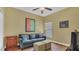 Cozy living room is furnished with a couch, two ottomans, and modern art at 14312 Paradise Tree Dr, Orlando, FL 32828