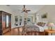Main bedroom with hardwood floors, ceiling fan, french doors, and a large dresser at 14312 Paradise Tree Dr, Orlando, FL 32828