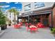 Outdoor dining area with red tables and chairs, palm trees, and restaurant facade at 14312 Paradise Tree Dr, Orlando, FL 32828