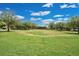 Scenic park with a large grassy area, mature trees, and a wooden structure in the distance at 14312 Paradise Tree Dr, Orlando, FL 32828