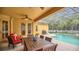 Wonderful outdoor patio with dining furniture, BBQ, and screened-in pool area at 14312 Paradise Tree Dr, Orlando, FL 32828