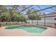 Relaxing pool area with screened enclosure, swimming pool, hot tub, and manicured landscaping at 14312 Paradise Tree Dr, Orlando, FL 32828