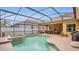 Inviting screened pool and spa area perfect for outdoor living and entertaining with dining area and barbecue at 14312 Paradise Tree Dr, Orlando, FL 32828