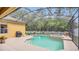 Backyard with a screened-in pool and spa, providing a private and relaxing outdoor space at 14312 Paradise Tree Dr, Orlando, FL 32828