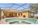 Well maintained backyard pool and spa with covered outdoor dining and barbecue area at 14312 Paradise Tree Dr, Orlando, FL 32828