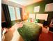 Bright bedroom featuring a large window, green walls, and cozy decor, creating a cheerful and inviting atmosphere at 14344 Desert Haven St, Windermere, FL 34786