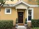 Welcoming front door with elegant wreath, decorative potted plants, and manicured hedges at 14344 Desert Haven St, Windermere, FL 34786