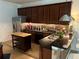 Kitchen with dark wood cabinets, granite countertops, stainless steel appliances, and a movable island at 14344 Desert Haven St, Windermere, FL 34786
