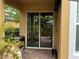 Outdoor patio area with sliding glass doors, featuring a grill and tropical plants for relaxing and entertaining at 14344 Desert Haven St, Windermere, FL 34786