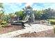 Community playground featuring a slide, climbing wall, and covered structure, all surrounded by lush landscaping at 14344 Desert Haven St, Windermere, FL 34786