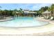 Large community pool surrounded by lounge chairs and lush landscaping, perfect for relaxation and recreation at 14344 Desert Haven St, Windermere, FL 34786