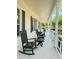 Exterior porch with rocking chairs and seating, offering a relaxing space to enjoy the surroundings at 14344 Desert Haven St, Windermere, FL 34786