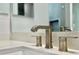 Close-up of modern bathroom faucet with quartz countertop and decorative handles at 148 Hampton Loop, Davenport, FL 33837
