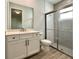 Modern bathroom with stylish vanity, large mirror, and glass-enclosed shower at 148 Hampton Loop, Davenport, FL 33837