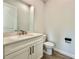 Stylish half bathroom featuring a modern vanity and fixtures at 148 Hampton Loop, Davenport, FL 33837