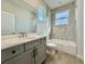 Modern bathroom featuring tile flooring, gray cabinets, and neutral-colored shower and tub at 148 Hampton Loop, Davenport, FL 33837