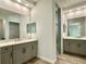 Bright bathroom featuring double vanity, quartz countertop, and walk-in shower at 148 Hampton Loop, Davenport, FL 33837