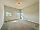 Sunlit bedroom featuring carpet floors, three windows, and neutral wall paint at 148 Hampton Loop, Davenport, FL 33837