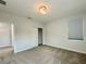 Bright bedroom featuring closet with sliding doors and light-colored carpet at 148 Hampton Loop, Davenport, FL 33837