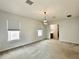 Bedroom featuring a light fixture, ensuite bathroom, and large window at 148 Hampton Loop, Davenport, FL 33837