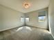 Carpeted bedroom filled with natural light from the three windows at 148 Hampton Loop, Davenport, FL 33837