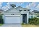 Charming one-story home featuring a tiled roof, well-manicured landscaping, and a two-car garage at 148 Hampton Loop, Davenport, FL 33837