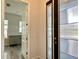 Modern foyer with dark wood door and sidelight panel, and an open view to the kitchen at 148 Hampton Loop, Davenport, FL 33837