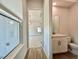 Hallway view to carpeted room and bathroom with a window at 148 Hampton Loop, Davenport, FL 33837