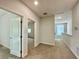 Bright hallway with carpet floors and doorways that lead to bedrooms at 148 Hampton Loop, Davenport, FL 33837