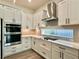 Modern kitchen showcasing white cabinets, stainless steel appliances, and stylish countertops at 148 Hampton Loop, Davenport, FL 33837