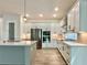 Modern kitchen featuring white cabinets, stainless steel appliances, and under cabinet lighting at 148 Hampton Loop, Davenport, FL 33837