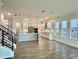 Open concept kitchen featuring stainless steel appliances, quartz countertops, wood-style floors at 148 Hampton Loop, Davenport, FL 33837