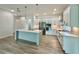 Bright kitchen with quartz island and countertops, stainless steel appliances, and wood-style floors at 148 Hampton Loop, Davenport, FL 33837