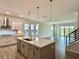 Well-lit kitchen featuring updated cabinetry, stainless steel appliances and modern backsplash at 148 Hampton Loop, Davenport, FL 33837