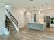 Open concept kitchen with an island, modern lighting, and an adjacent staircase at 148 Hampton Loop, Davenport, FL 33837
