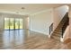 Bright, open living room with tile floors and sliding glass doors to backyard at 148 Hampton Loop, Davenport, FL 33837