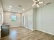 Bright living room featuring modern lighting, wood-look tile floors, and a convenient wet bar at 148 Hampton Loop, Davenport, FL 33837