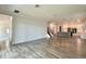 Open-concept living room featuring tile flooring, stairs, and a modern kitchen at 148 Hampton Loop, Davenport, FL 33837