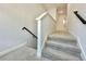 Carpeted staircase with white railing leading to the upper level of the home at 148 Hampton Loop, Davenport, FL 33837