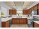 Well-lit kitchen with white countertops, warm wood cabinets, modern appliances, and tiled floors at 1508 Southwind Ct, Casselberry, FL 32707