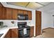 Well-lit kitchen featuring white countertops, warm wood cabinets, modern appliances, and tiled floors at 1508 Southwind Ct, Casselberry, FL 32707