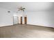 Spacious living room featuring wood floors, a ceiling fan, a front door, and two storage closets at 1508 Southwind Ct, Casselberry, FL 32707
