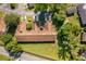 Aerial view showcases property with manicured lawns and mature trees at 168 Hill St, Casselberry, FL 32707
