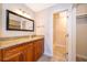 Bathroom featuring granite countertops, wood cabinets, large mirror, and an open shower area at 168 Hill St, Casselberry, FL 32707