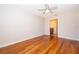 Bedroom with hardwood floors, a ceiling fan, and a door leading to the en-suite bathroom at 168 Hill St, Casselberry, FL 32707