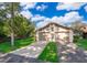 Two-car garage with well-manicured lawn and lush landscaping at 168 Hill St, Casselberry, FL 32707