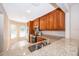 Spacious kitchen featuring granite counters, stainless appliances, and wooden cabinetry at 168 Hill St, Casselberry, FL 32707