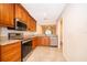 Well-equipped kitchen featuring granite countertops, stainless steel appliances, and classic wood cabinets at 168 Hill St, Casselberry, FL 32707